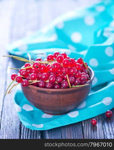 red currant in bowl and on a table