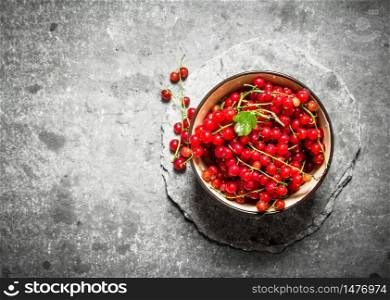 Red currant in the Cup. On the stone table.. Red currant in the Cup. On stone table.