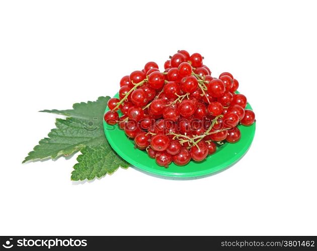 Red currant on small plates decorated with leaves isolated