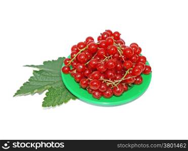 Red currant on small plates decorated with leaves isolated