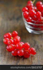 Red currants isolated on wood background