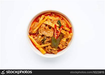 Red curry preserved bamboo shoot with pork, white background.