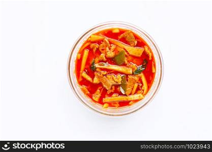 Red curry preserved bamboo shoot with pork, white background.