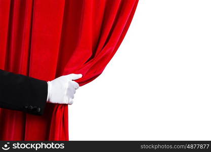 Red curtain. Close up of hand in white glove open the curtain. Place for text