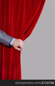 Red curtain. Close up of hand opening red curtain. Place for text