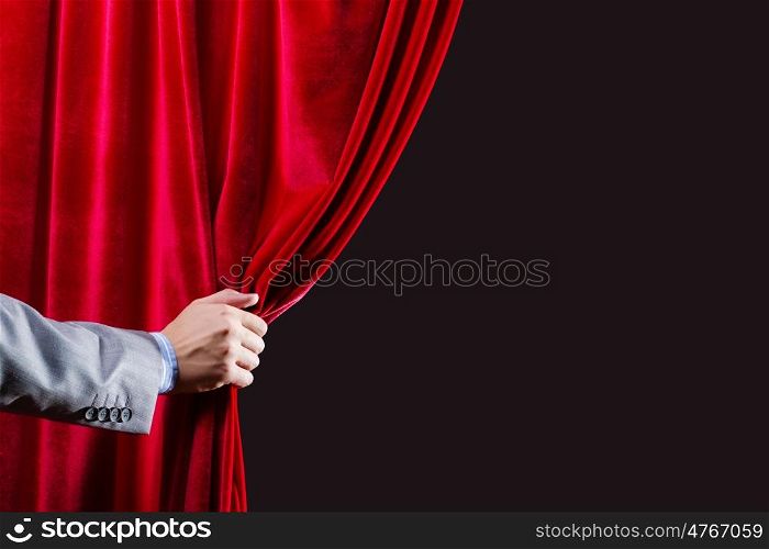 Red curtain. Close up of hand opening red curtain. Place for text