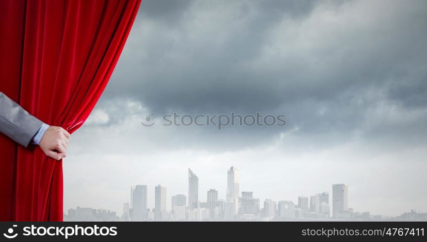 Red curtain. Close up of hand opening red velvet curtain