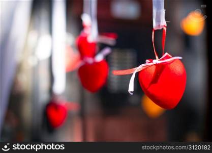 Red decorative heart hanging on the ribbon