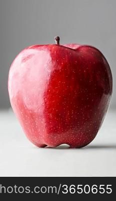 red delicious apple on gray background