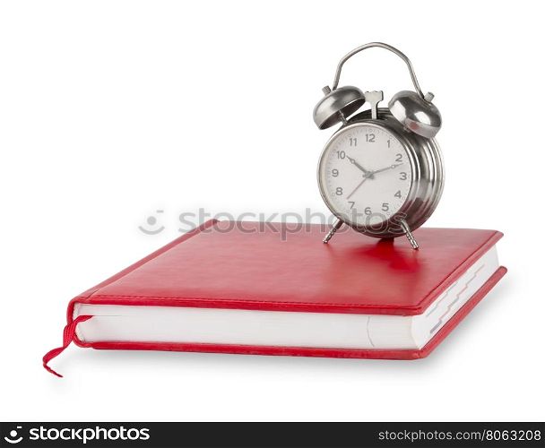 Red diary and old alarm clock isolated on white background. Red diary and old alarm clock