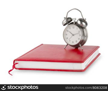 Red diary and old alarm clock isolated on white background. Red diary and old alarm clock