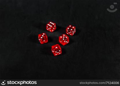 red dices on black carpet background