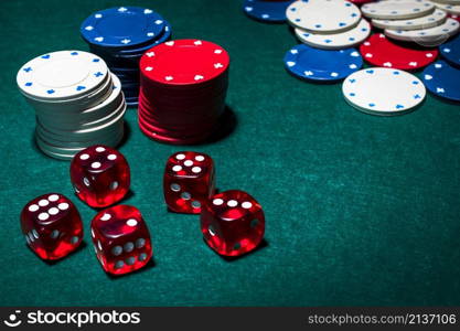 red dices stack gambling chips green poker table