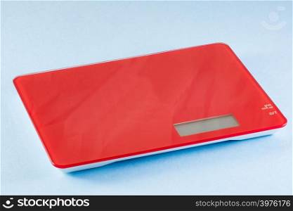 Red Digital Electronic Kitchen Scale isolated on blue background