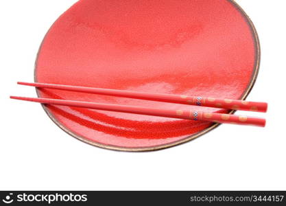 Red dish and chopsticks with oriental style on a white background