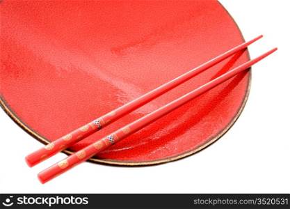 Red dish and chopsticks with oriental style on a white background