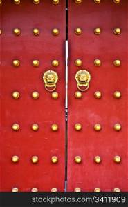 Red door in hutong area, close to Forbidden City, Beijing, China