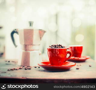 Red espresso coffee cup on table at light background with coffee pot, front view