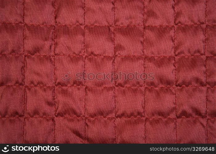 Red fabric texture with sewing square pattern textile