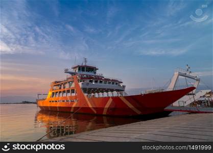 Red ferry on the port in Greece at sunset