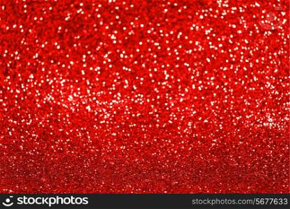 Red festive glitter background with defocused lights