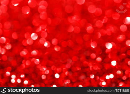 Red festive glitter background with defocused lights