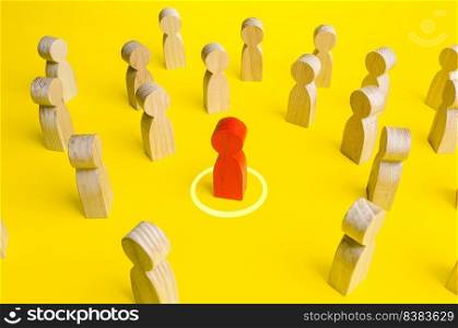Red figurine of a man in a circle in crowd of people. Personal space, comfort zone. Maintaining distance to avoid contact and infection. Identification of infected persons and isolation from society.