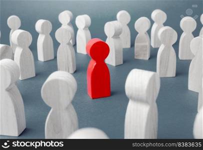 Red figurine of a man in a crowd of people. Stranger, eye-catching. Different, special. Infected carrying threat of spread of a pandemic. Collective immunity. Social distance. Intruder detection