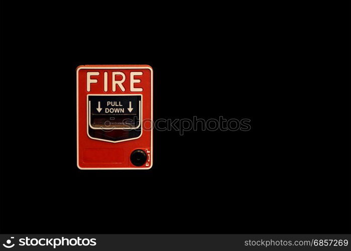 red fire alarm box on black background