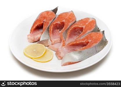 Red fish bit with lemon on plate on white background