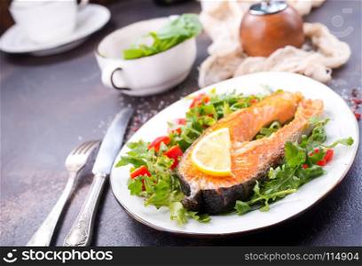 red fish on plate and on a table