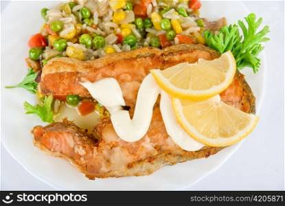 Red fish rice and vegetable closeup dish isolated on white