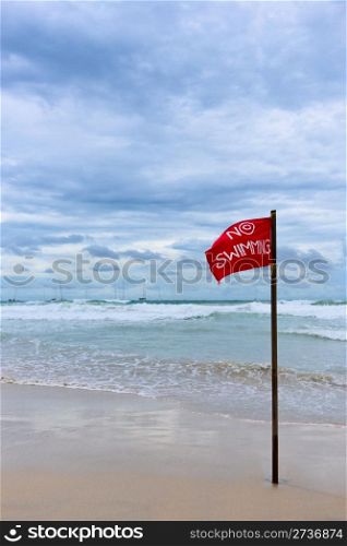 "Red flag with warning text "no swimming""