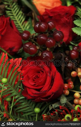 Red flower arrangement with mixed flowers and berries