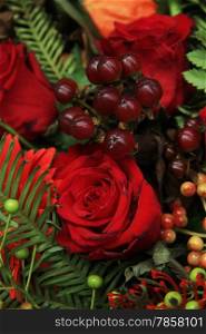 Red flower arrangement with mixed flowers and berries