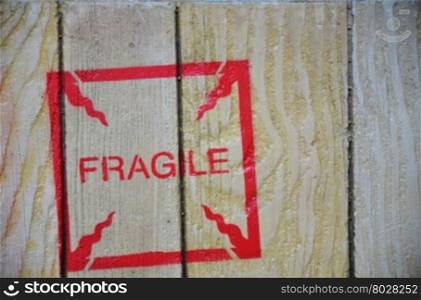 Red fragile stenciled on shipping packing crate