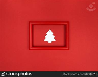 Red frame, with white wooden Christmas tree toy inside.. Red frame, with white wood Christmas tree toy inside.