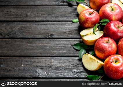 Red fresh apples and Apple slices. On wooden background.. Red fresh apples and Apple slices.