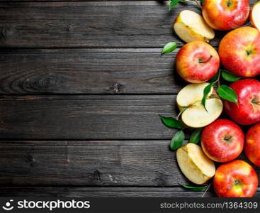 Red fresh apples and Apple slices. On wooden background.. Red fresh apples and Apple slices.