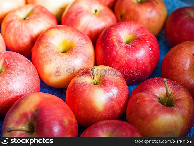 red, fresh apples as a background