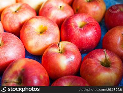 red, fresh apples as a background