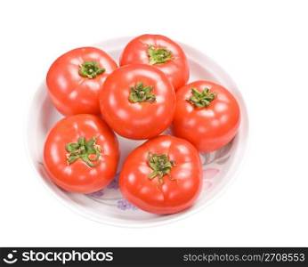 Red fresh tomatoes in dish, isolated on white background