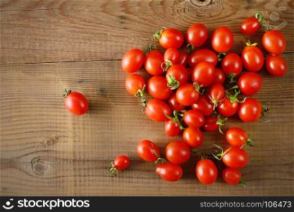 Red fresh tomatoes on wooden table. Vegetable background. Top view. Copy space.