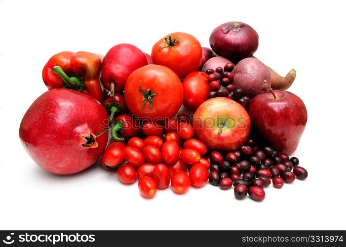 Red Fruit And Vegetables. Vegetables and fruit all of red coloring including pomegranate, red pears, large and cherry tomatoes, apples, sweet potato, chilie peppers and cranberries.
