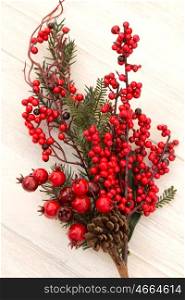 Red fruits on the branch Christmas for decoration on a wooden background