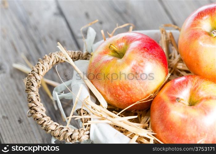 Red gala apples in a wicker basket