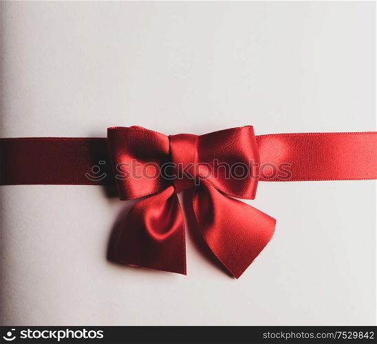 Red gift bow on white background holiday gift concept. Red gift bow on white