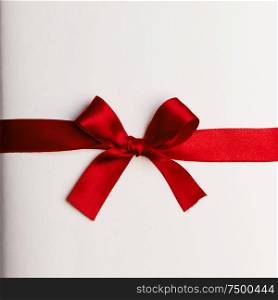Red gift bow on white background. Red gift bow on white