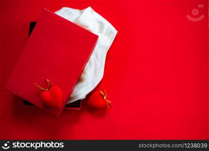 red gift box on red background - valentine&rsquo;s