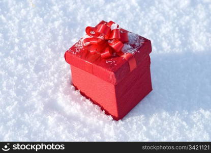 Red gift box on snow